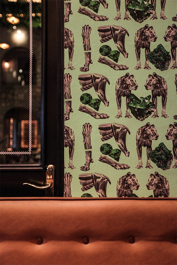 Detalle de pared con papel tapiz artístico y butacas en restaurante Patria Chica, acabados interiores Fer Et Ciment